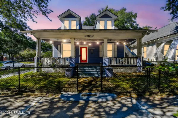 a front view of a house with a yard table and chairs