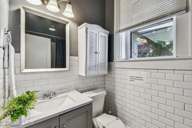 a bedroom with a bed and a mirror