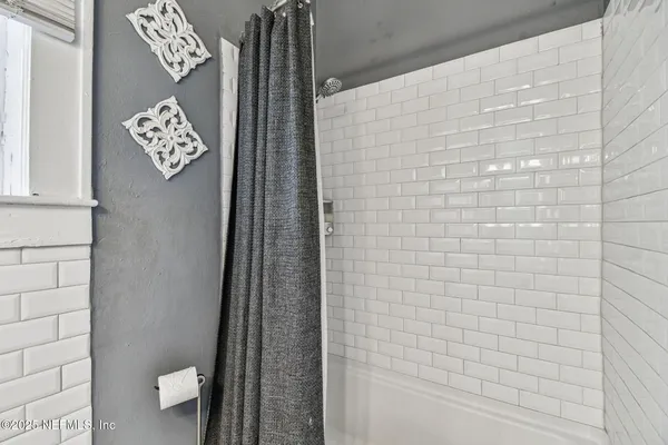 a living room with stainless steel appliances kitchen island granite countertop furniture and a window