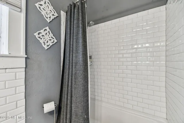 a living room with stainless steel appliances kitchen island granite countertop furniture and a window