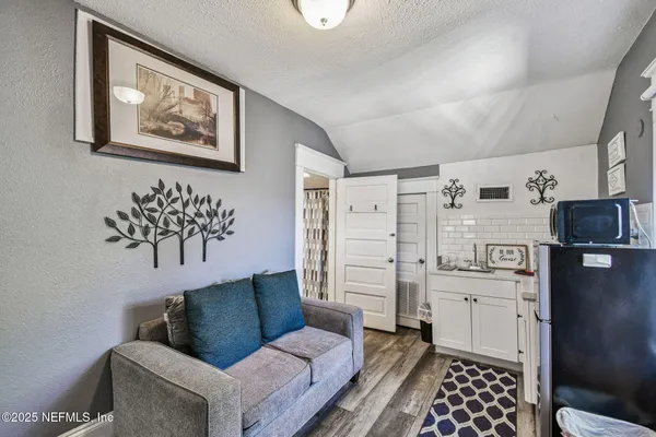 a kitchen with a sink toilet and cabinets