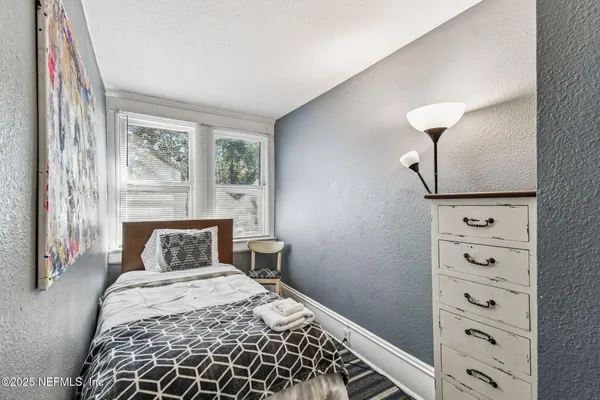 a bed room with a bed and a window