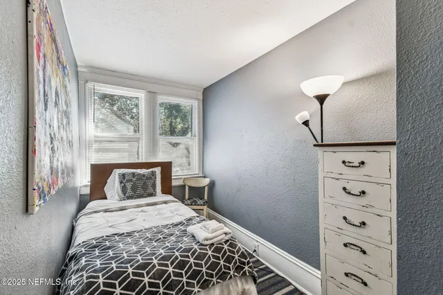 a bed room with a bed and a window