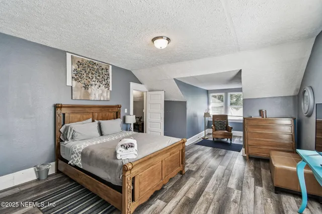 a bedroom with a bed and a chair