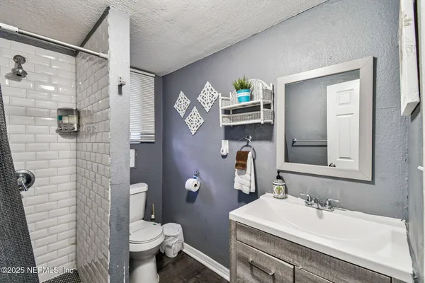 an aerial view of a house with a yard and lake view