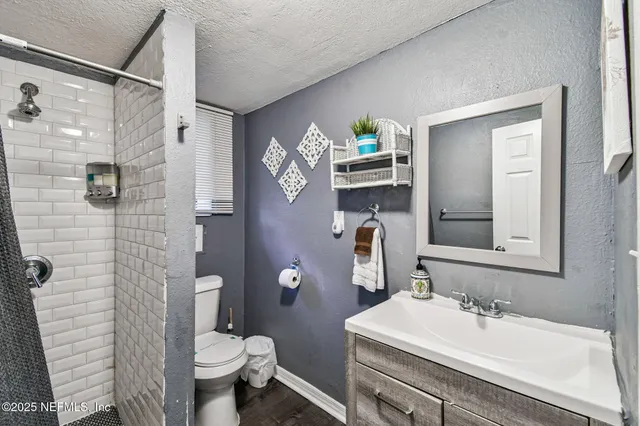 an aerial view of a house with a yard and lake view