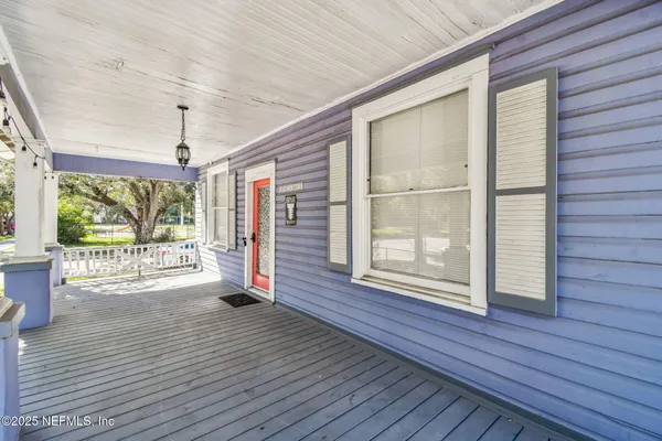 a living room with furniture a chandelier and a flat screen tv