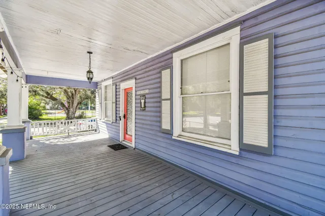 a living room with furniture a chandelier and a flat screen tv