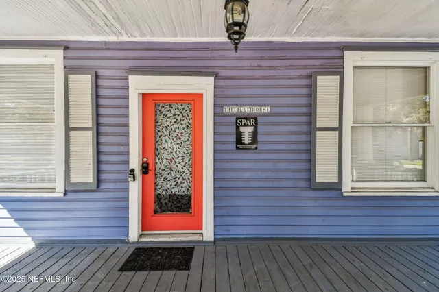a living room with furniture chandelier and a window