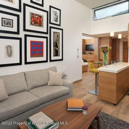 a living room with furniture kitchen view and a window