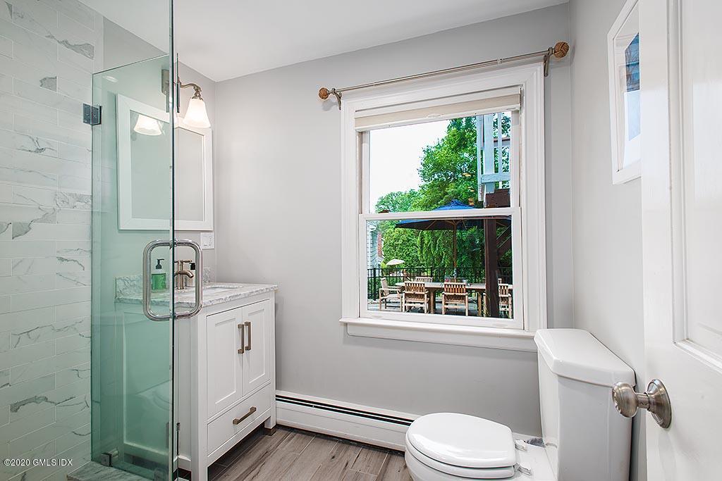 27 Juniper Lane Riverside, CT 06878 - Photo 15 of 19 a bathroom with a toilet a sink a window and mirror