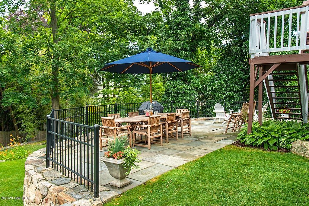 27 Juniper Lane Riverside, CT 06878 - Photo 5 of 19 a view of a table and chairs under an umbrella