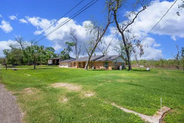 an aerial view of a house with a garden and trees