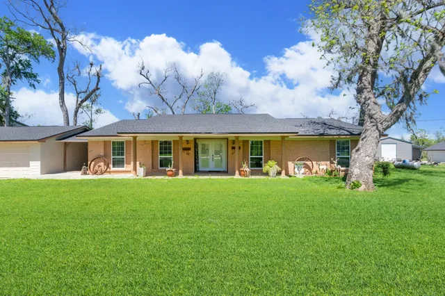 a view of an house with backyard space and balcony