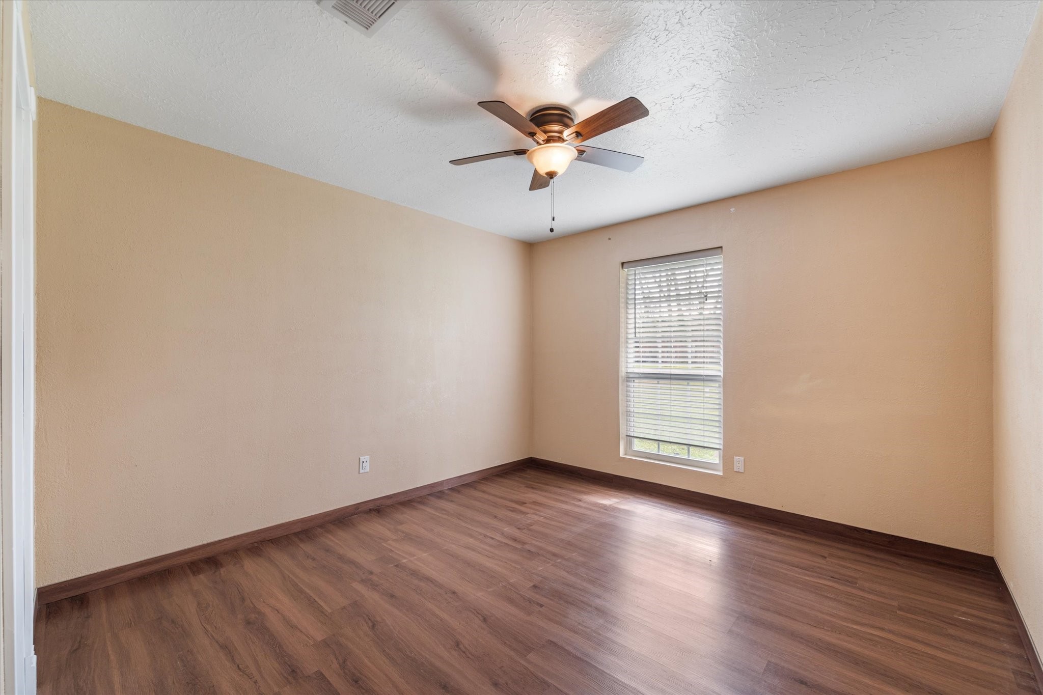 400 Pecan Estates Road, Unit C616R Angleton, TX 77515 - Photo 38 of 49 an empty room with wooden floor fan and windows