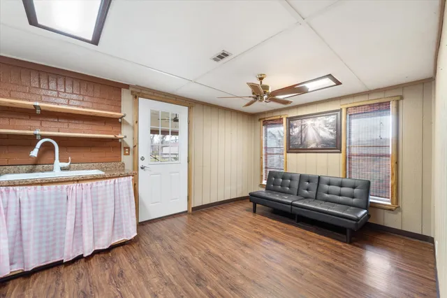 a living room with furniture and wooden floor