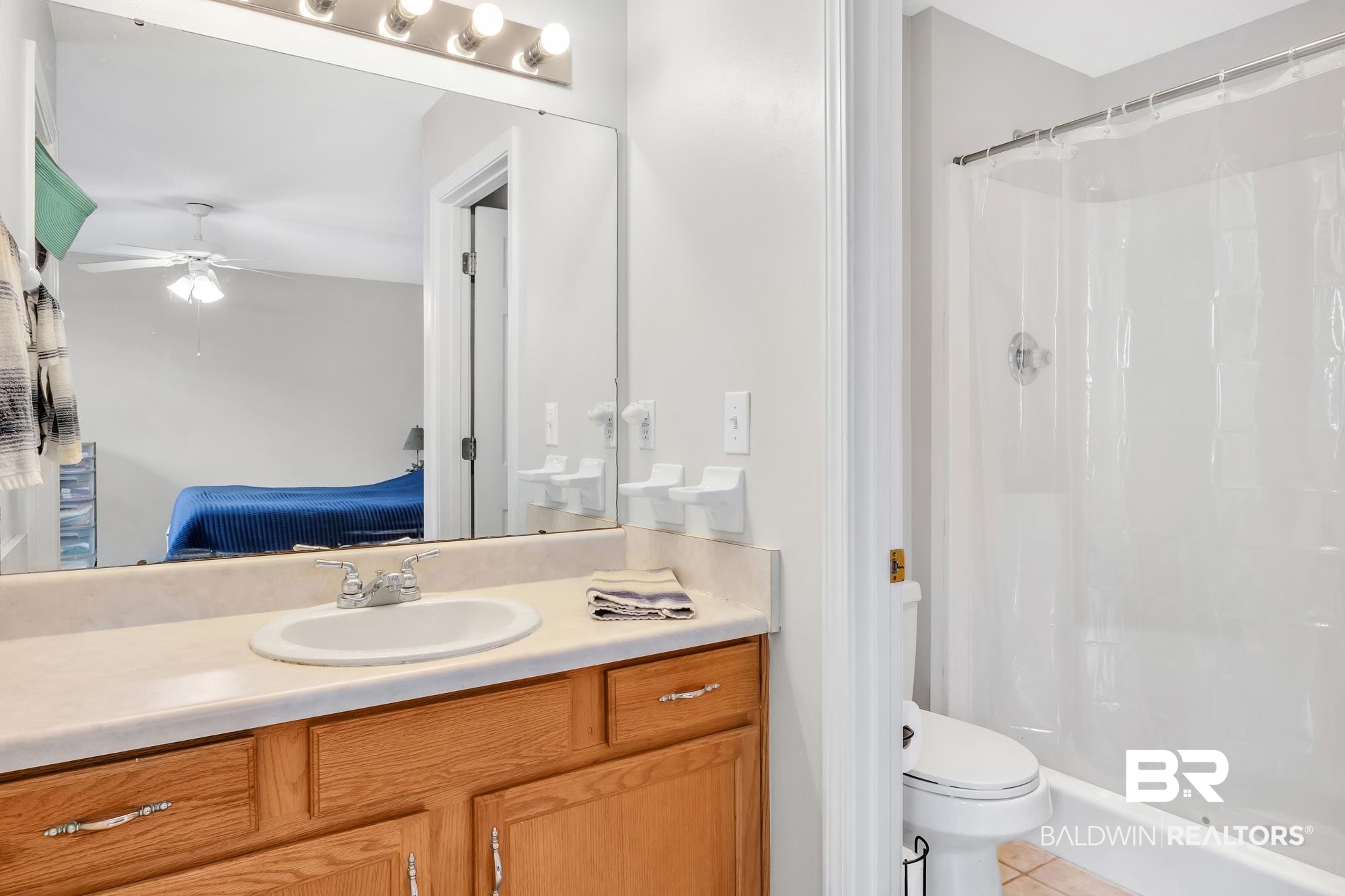 105 Cluster Oaks Court Foley, AL 36535 - Photo 22 of 26 Bathroom featuring vanity, ensuite bathroom, curtained shower, tile patterned floors, and a ceiling fan
