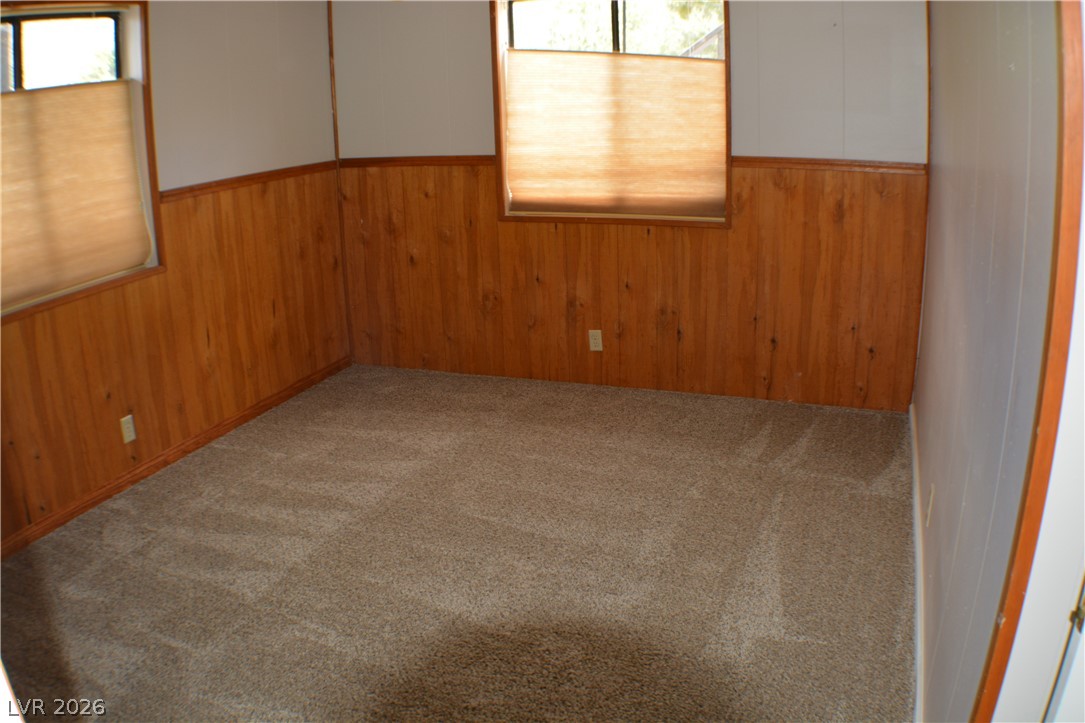 1321 Trout Canyon Road Las Vegas, NV 89124 - Photo 25 of 50 A cozy retreat features a blend of paneling and soft carpeting, creating a welcoming atmosphere.