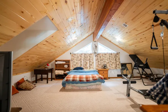 a bedroom with a bed and a workspace