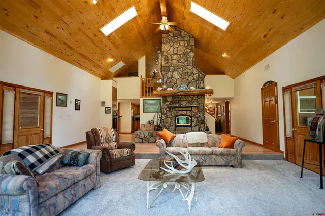 a living room with furniture a fireplace and a chandelier