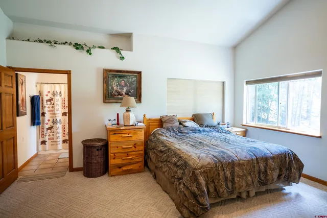 a bedroom with bed and window