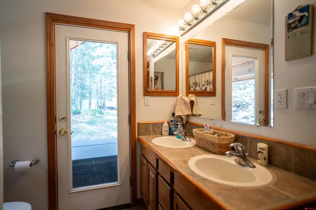 a bathroom with a sink double vanity and a mirror
