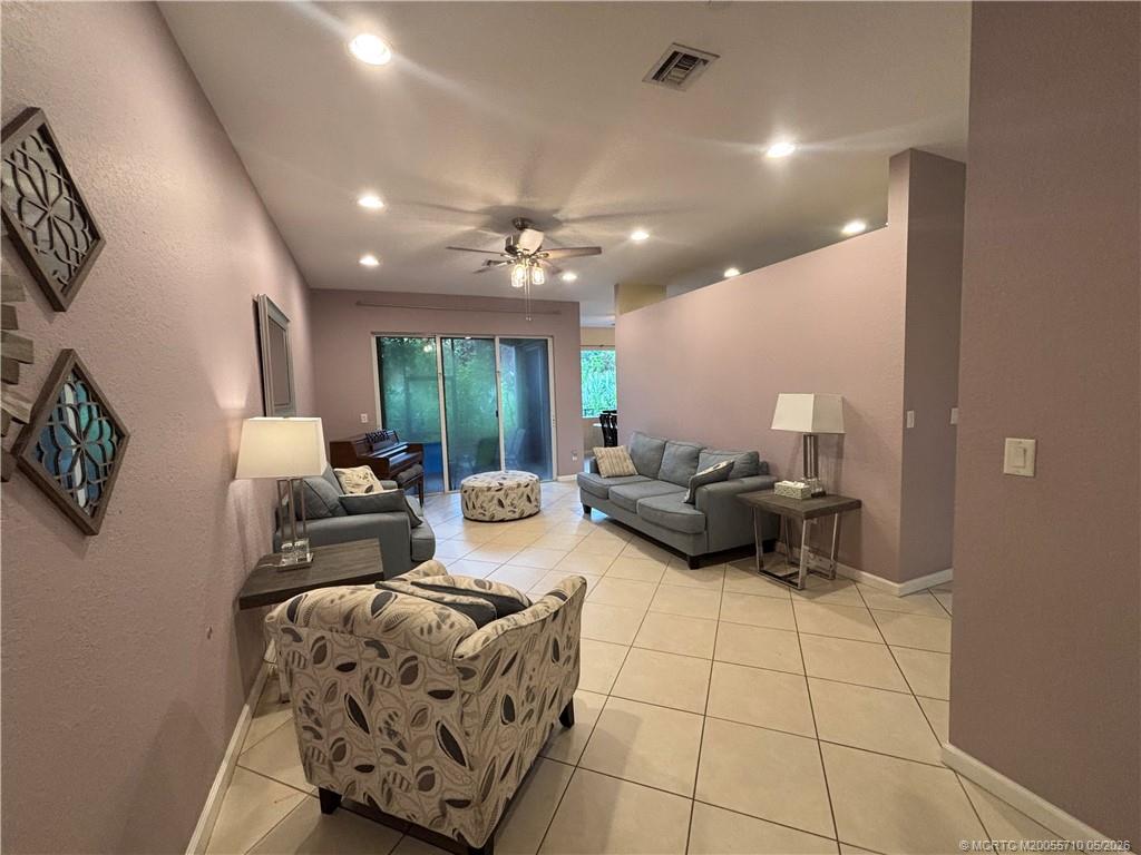262 Southwest Walking Path, Unit 262 Stuart, FL 34997 - Photo 17 of 39 a living room with furniture and a chandelier