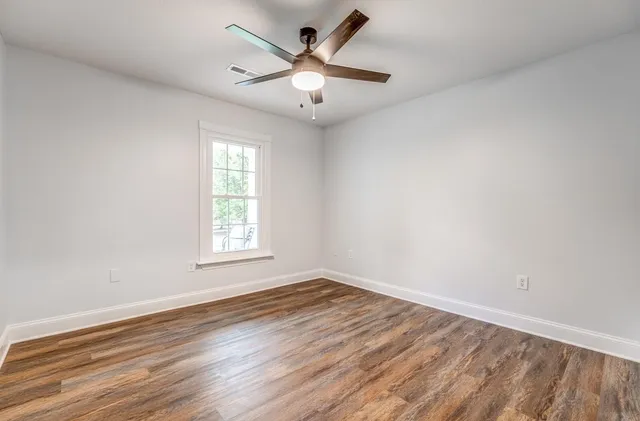 a bathroom with a granite countertop sink a toilet and a mirror