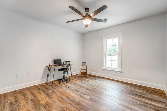 a kitchen with granite countertop white cabinets and sink