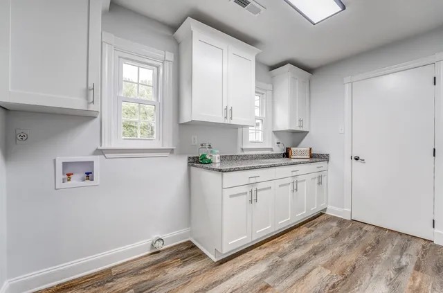 a view of room with window and wooden floor