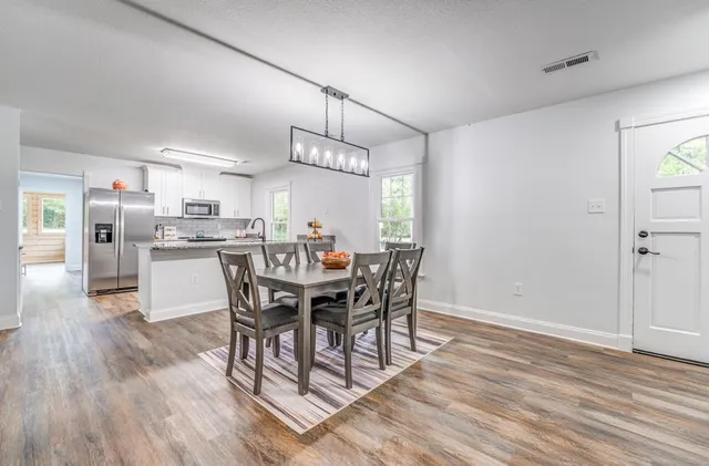 a view of a dining room with furniture window and wooden floor