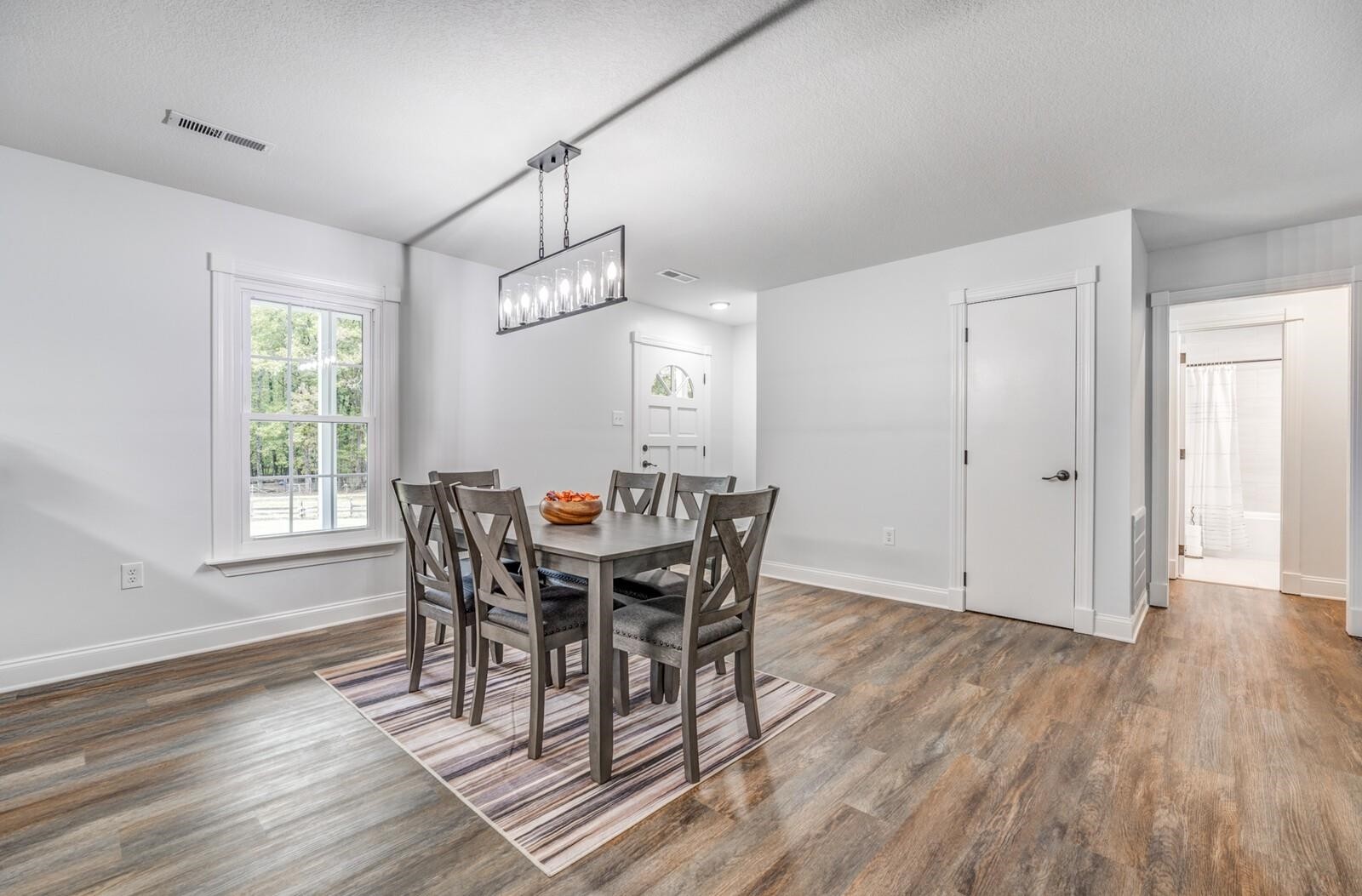 2100 Scrub Oak Road Mason, TN 38049 - Photo 7 of 28 a view of a dining room with furniture window and wooden floor