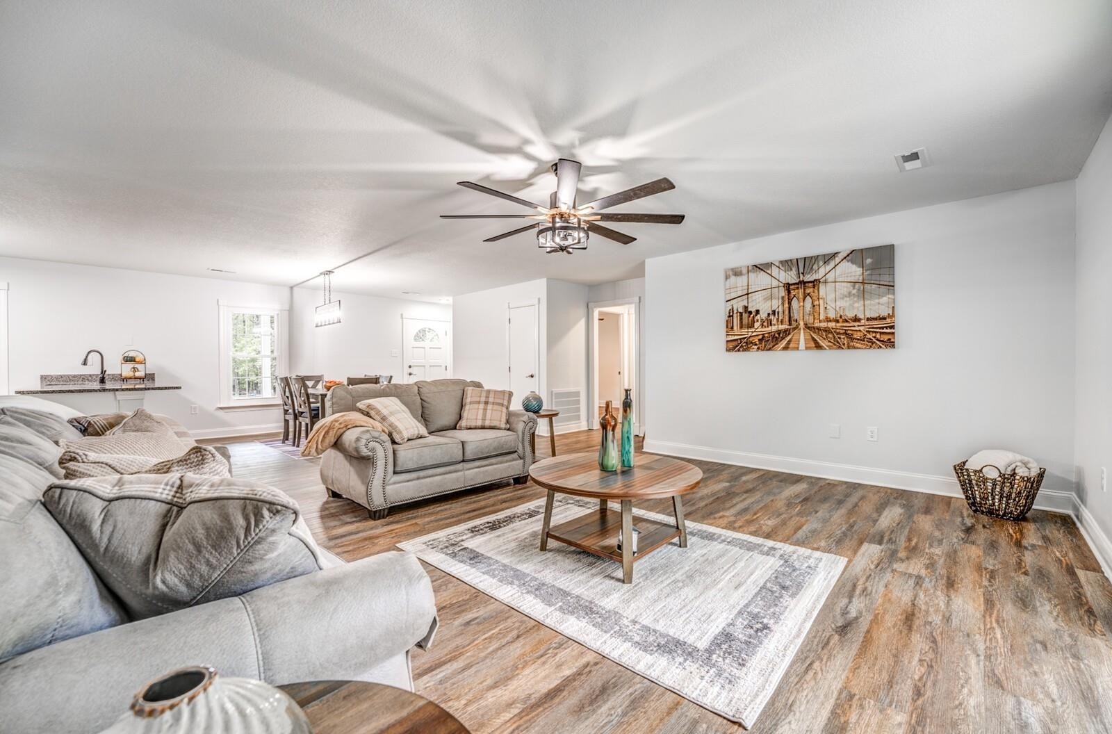 2100 Scrub Oak Road Mason, TN 38049 - Photo 8 of 28 a living room with furniture a rug and a chandelier