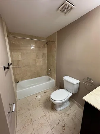 a bathroom with a toilet and a bath tub
