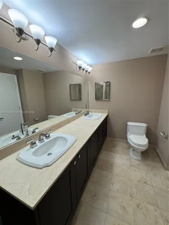 a bathroom with a sink double vanity and a mirror