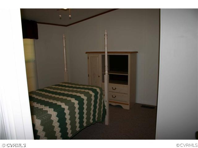 3244 Lowry Road Columbia, VA 23038 - Photo 12 of 12 a bedroom with a bed and a walk in closet