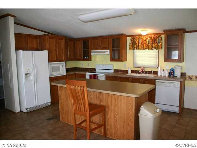 3244 Lowry Road Columbia, VA 23038 - Photo 6 of 12 a kitchen with stainless steel appliances a sink a refrigerator a counter space and a window