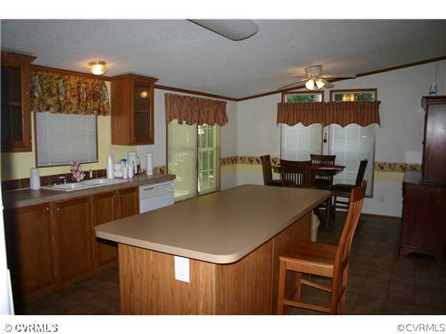 3244 Lowry Road Columbia, VA 23038 - Photo 7 of 12 a kitchen with a table and chairs in it