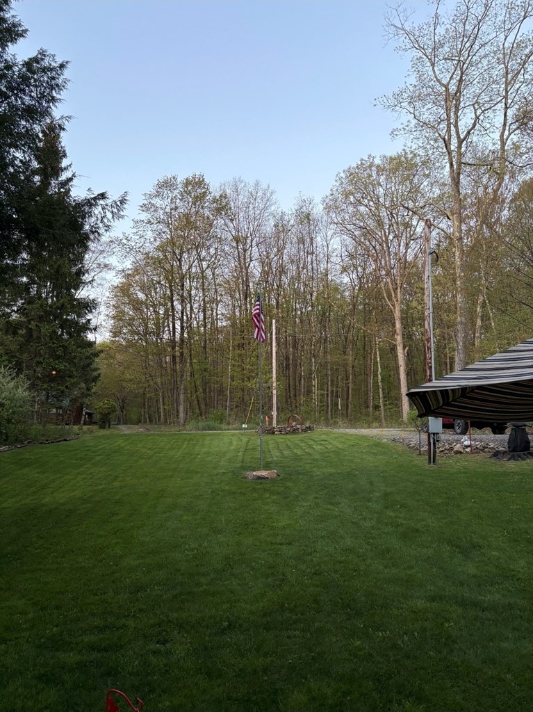 481 Twin Oaks Road Polk, PA 16342 - Photo 22 of 23 a backyard of a house with lots of green space and trampoline