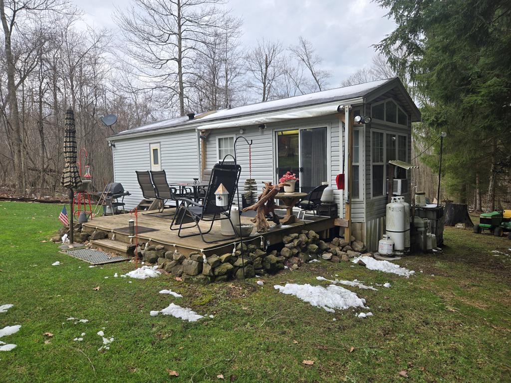 481 Twin Oaks Road Polk, PA 16342 - Photo 6 of 23 a view of a house with backyard sitting area and garden