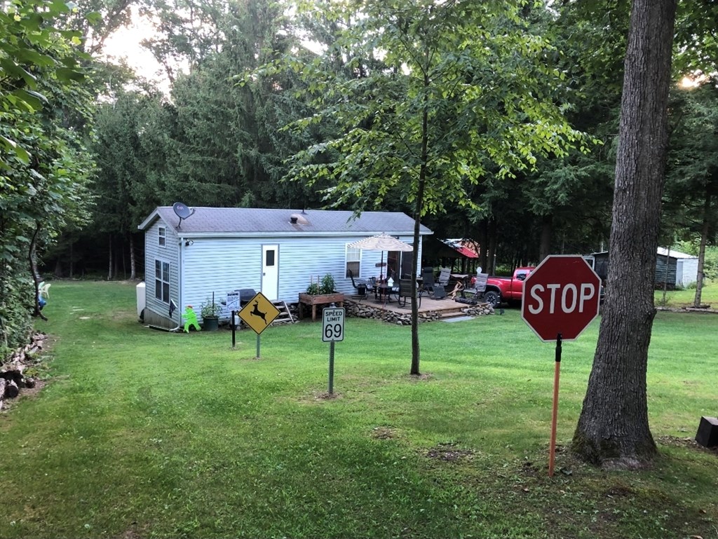 481 Twin Oaks Road Polk, PA 16342 - Photo 8 of 23 a view of backyard with table and chairs