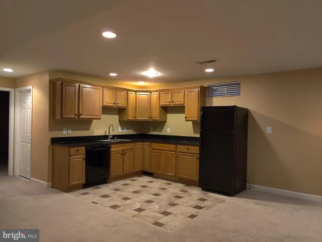 a kitchen with a refrigerator and a sink