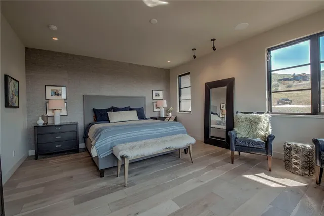 a spacious bedroom with a large bed and a dresser