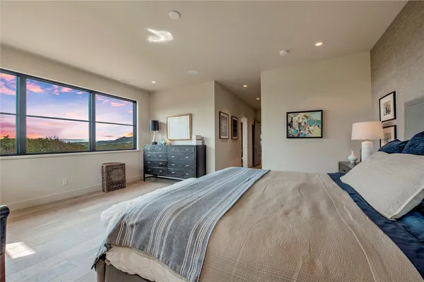 a bathroom with a tub sink double vanity and mirror