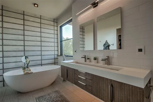 a bedroom with furniture and a large window