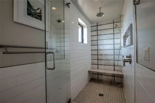 a bedroom with furniture and a large window