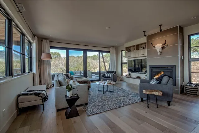 a living room with furniture flat screen tv and a fireplace