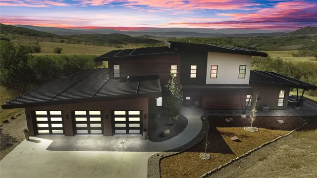 a view of a patio with couches table and chairs and wooden floor
