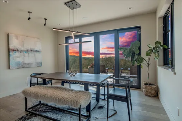 a bedroom with a bed table chair and a window