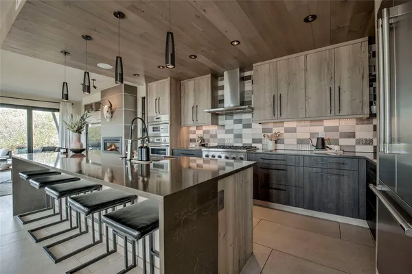 a kitchen with a stove a sink and a refrigerator